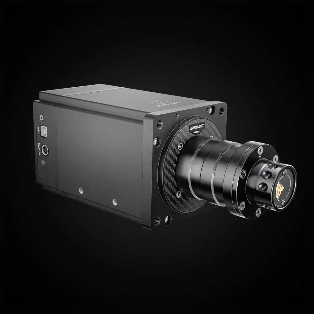 Simagic Alpha direct-drive wheel base, three-quarter view of the black aluminum housing with a carbon-fiber front ring, the quick-release shaft, and the USB and power sockets on the left flank